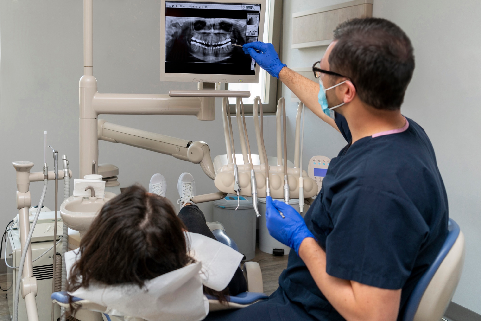 Dentist discussing a treatment X-ray with a patient